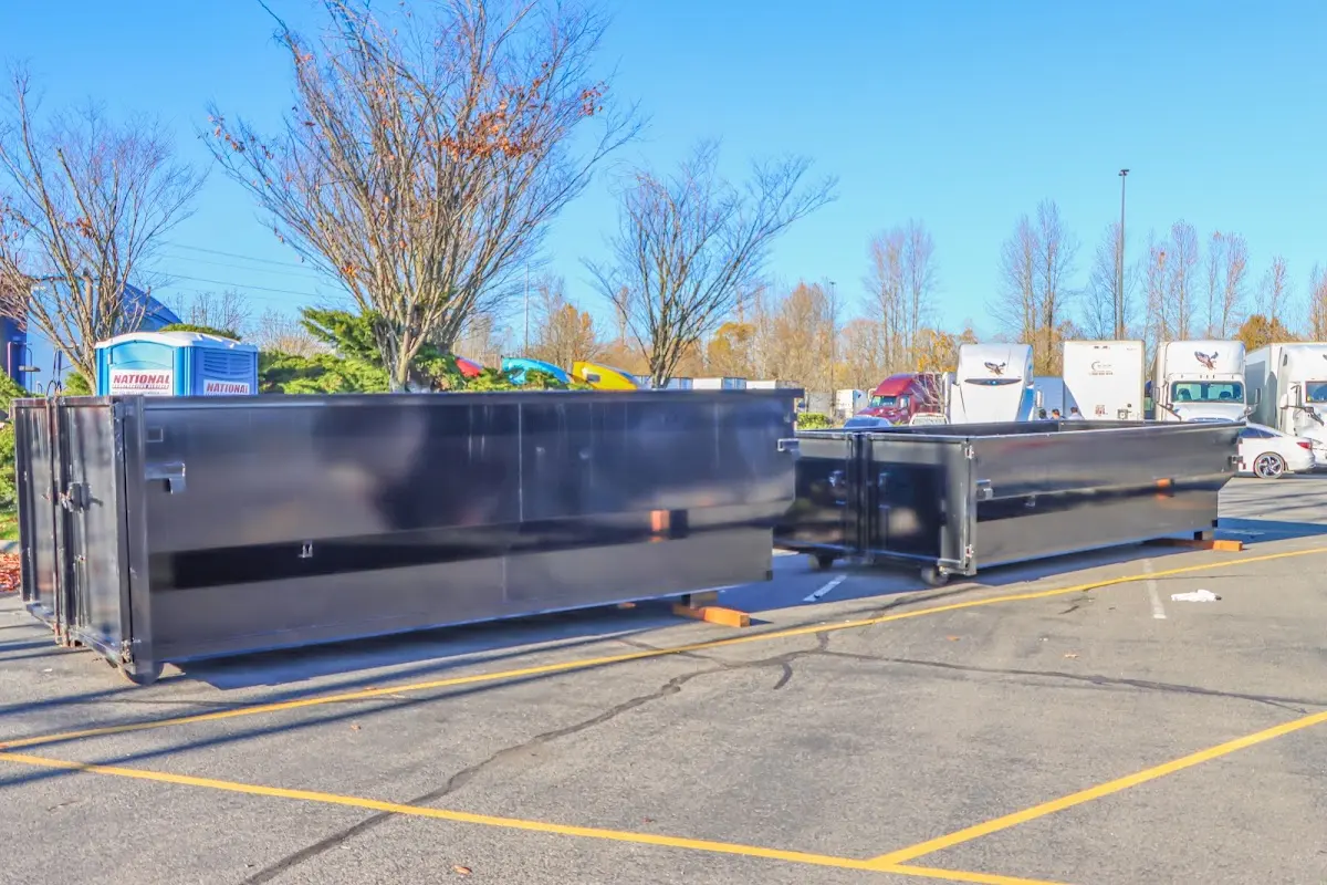 Professional dumpster rental service with roll-off container on residential driveway in Festus